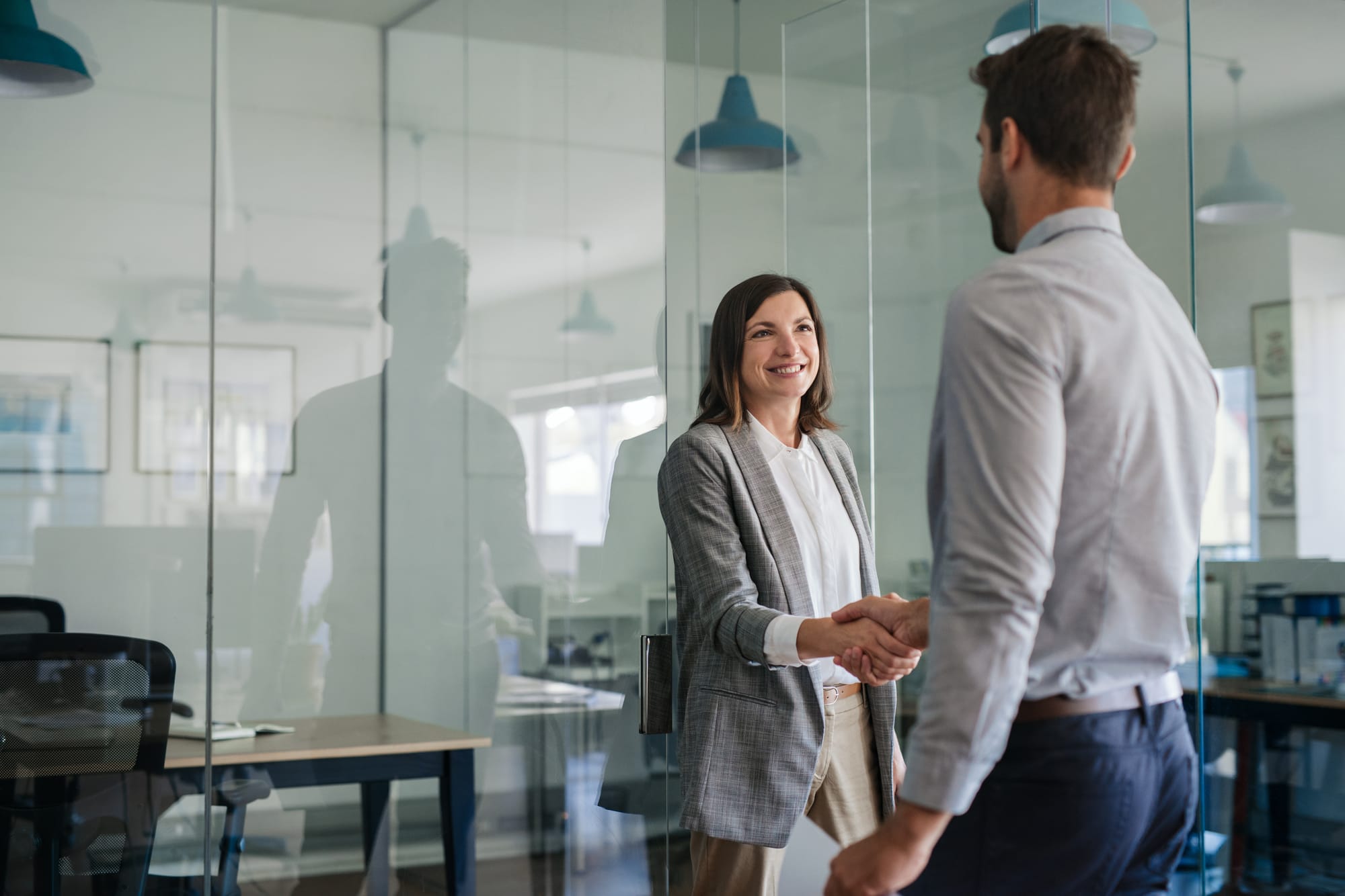 Interviewer warmly greeting candidate before asking about their greatest strength.